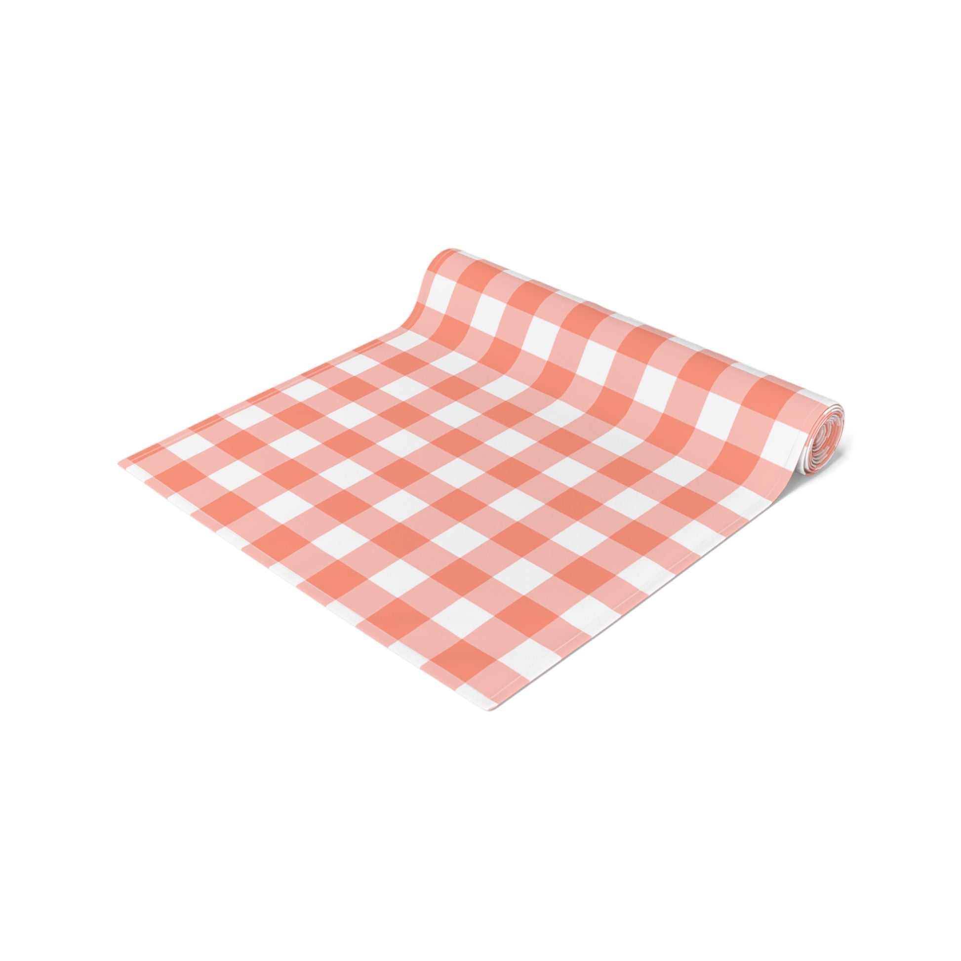 Red and white gingham checkered table runner rolled up on a white background