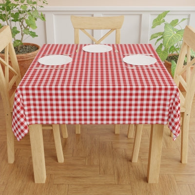 Round table with a red and white checkered gingham tablecloth on a white background