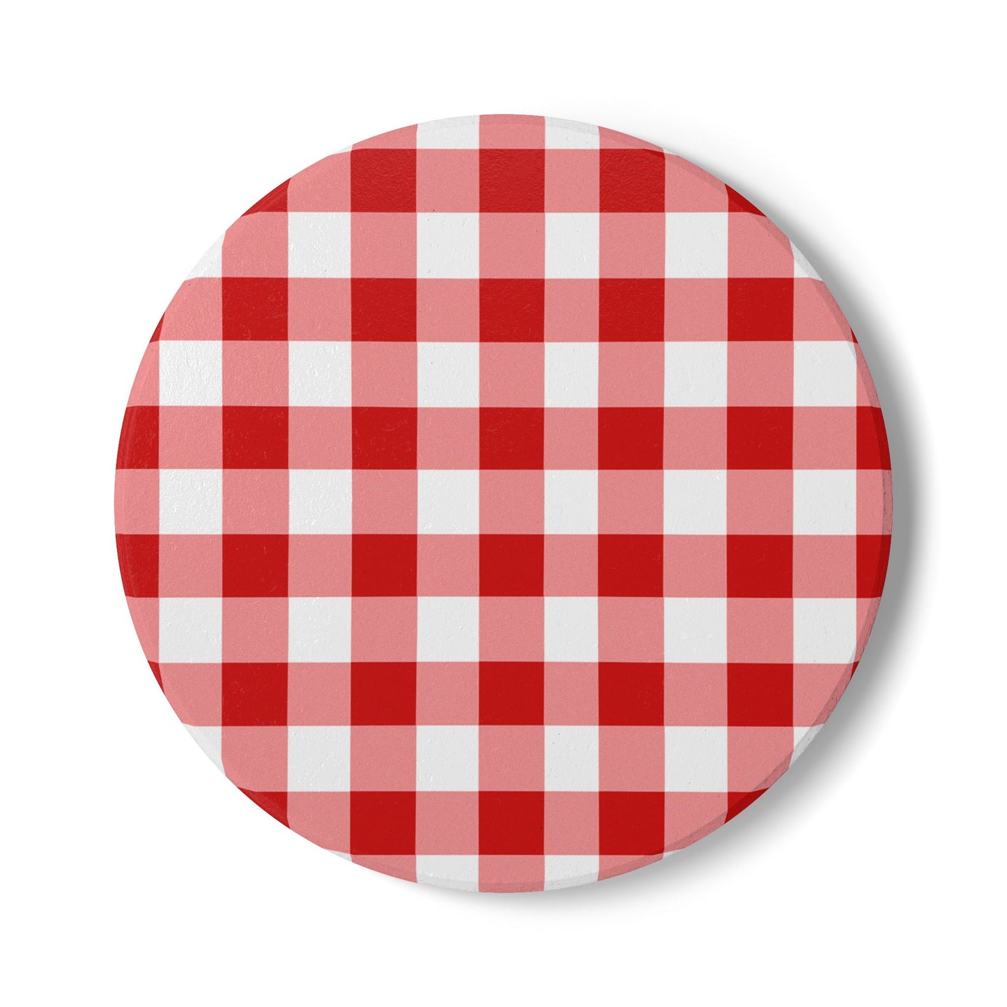 Red gingham round ceramic tile coaster with red and white checkered pattern on front of coaster, on a white background.