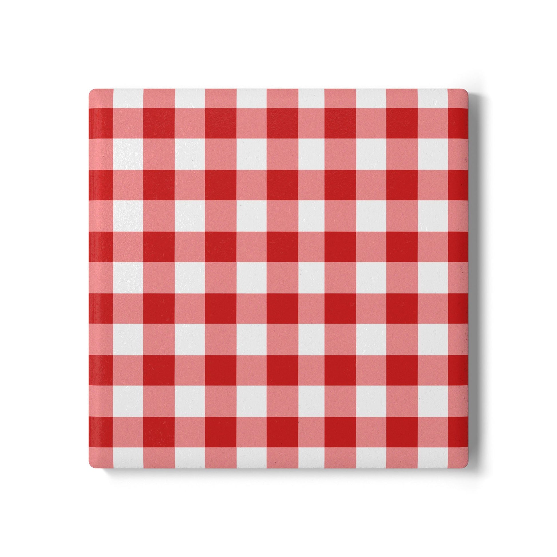 Red gingham square ceramic tile coaster with red and white checkered pattern on front of coaster, on a white background.