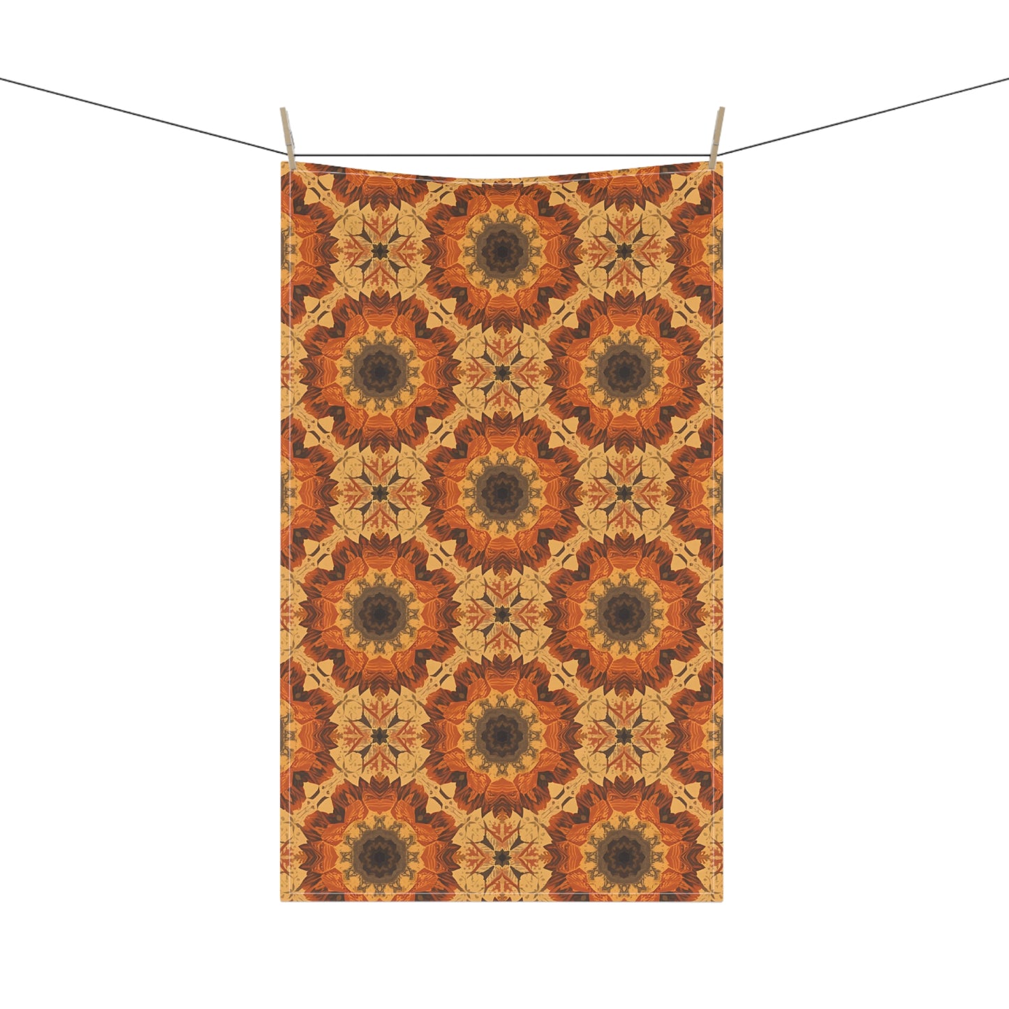 Decorative tye-dye orange  geometric pattern hanging on a line against a white background