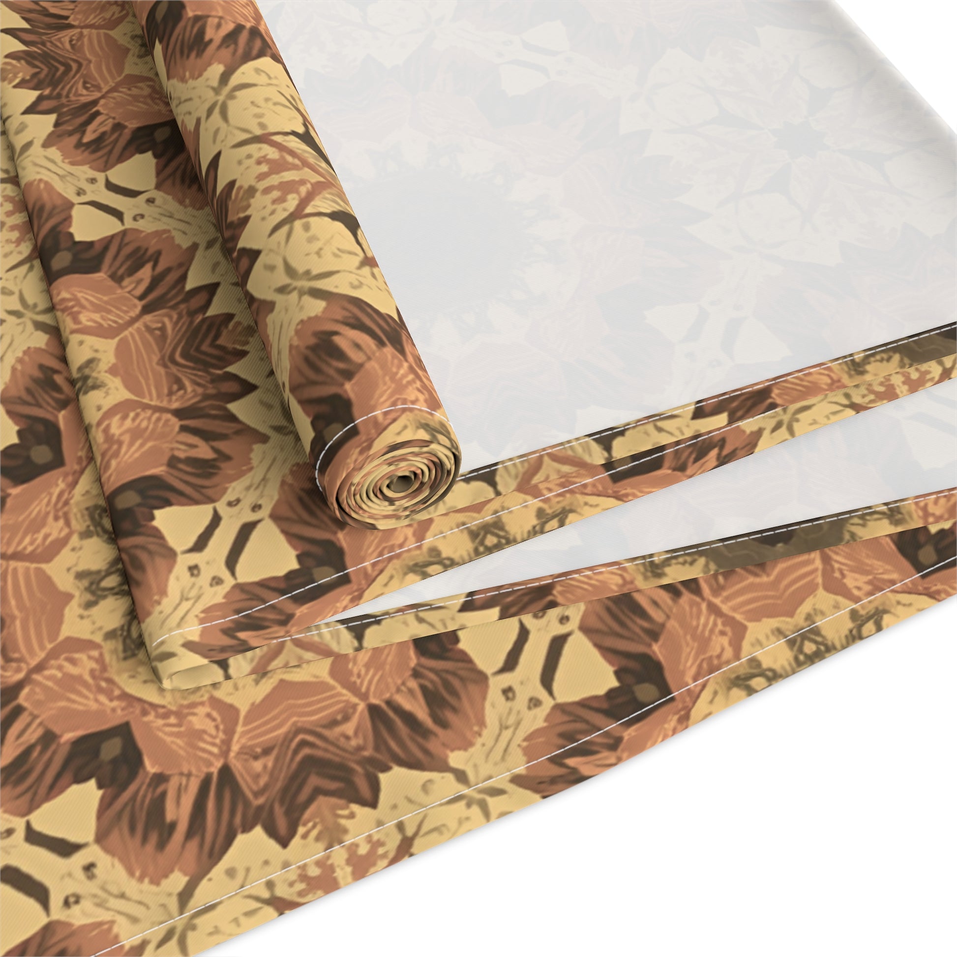 Roll of orange, gray and yellow tye-dye floral-patterned cotton table runner on a white background