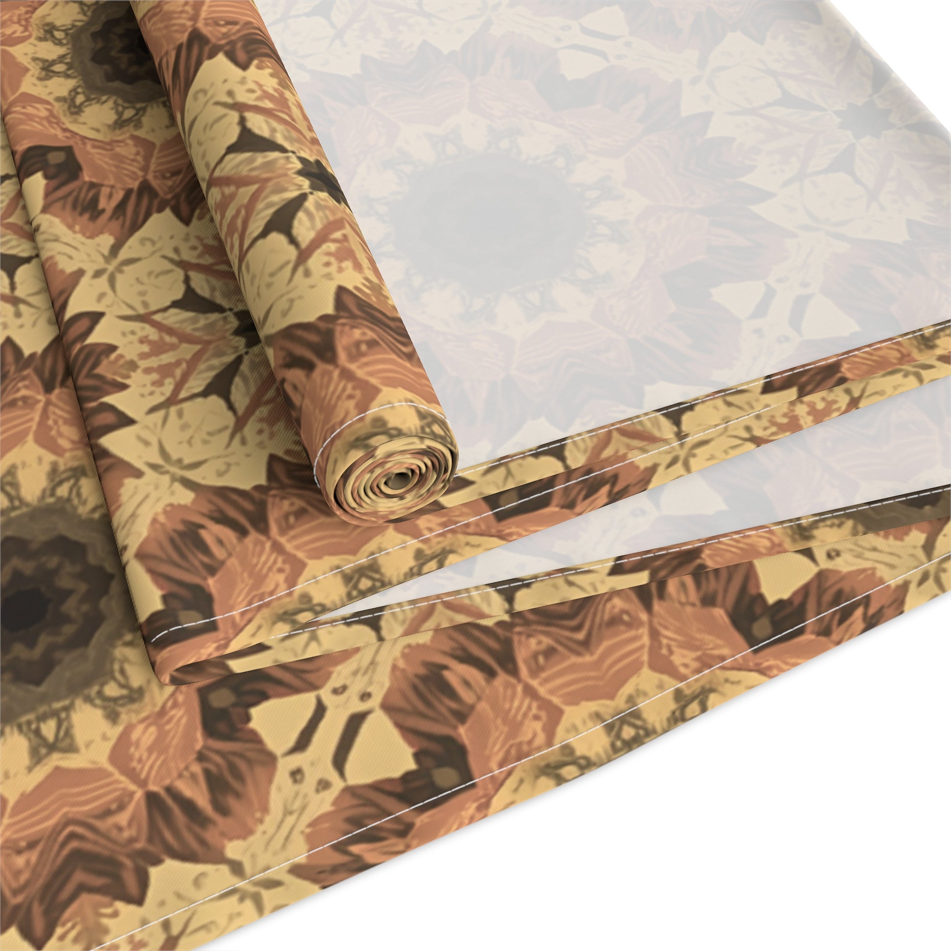 Roll of orange, yellow and gray tye-dye floral-patterned table runner on a white background