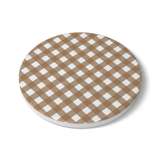 Round ceramic tile coaster with brown and white gingham checkered pattern on a white background