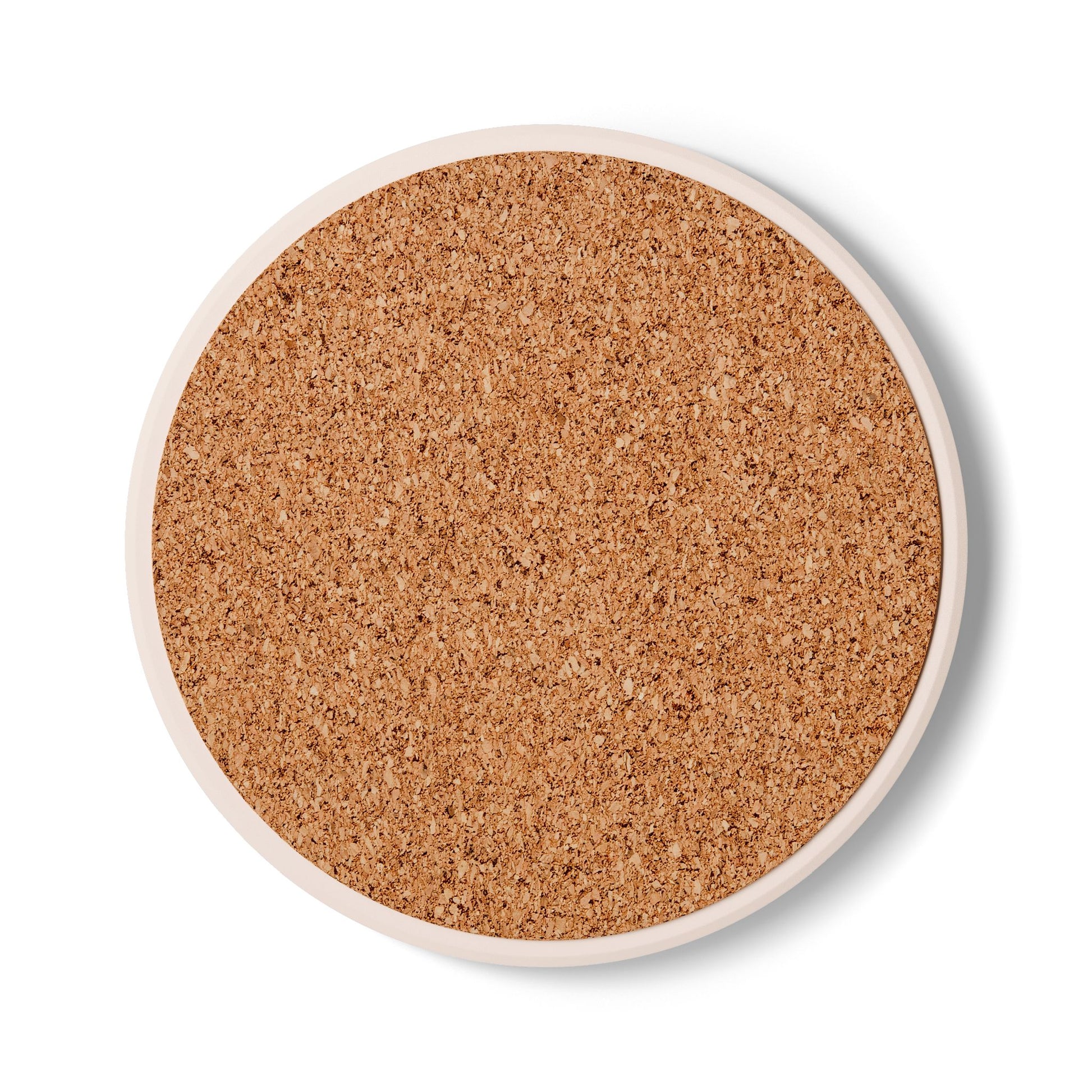 Back view of round ceramic tile coastere with cork backing on a white background