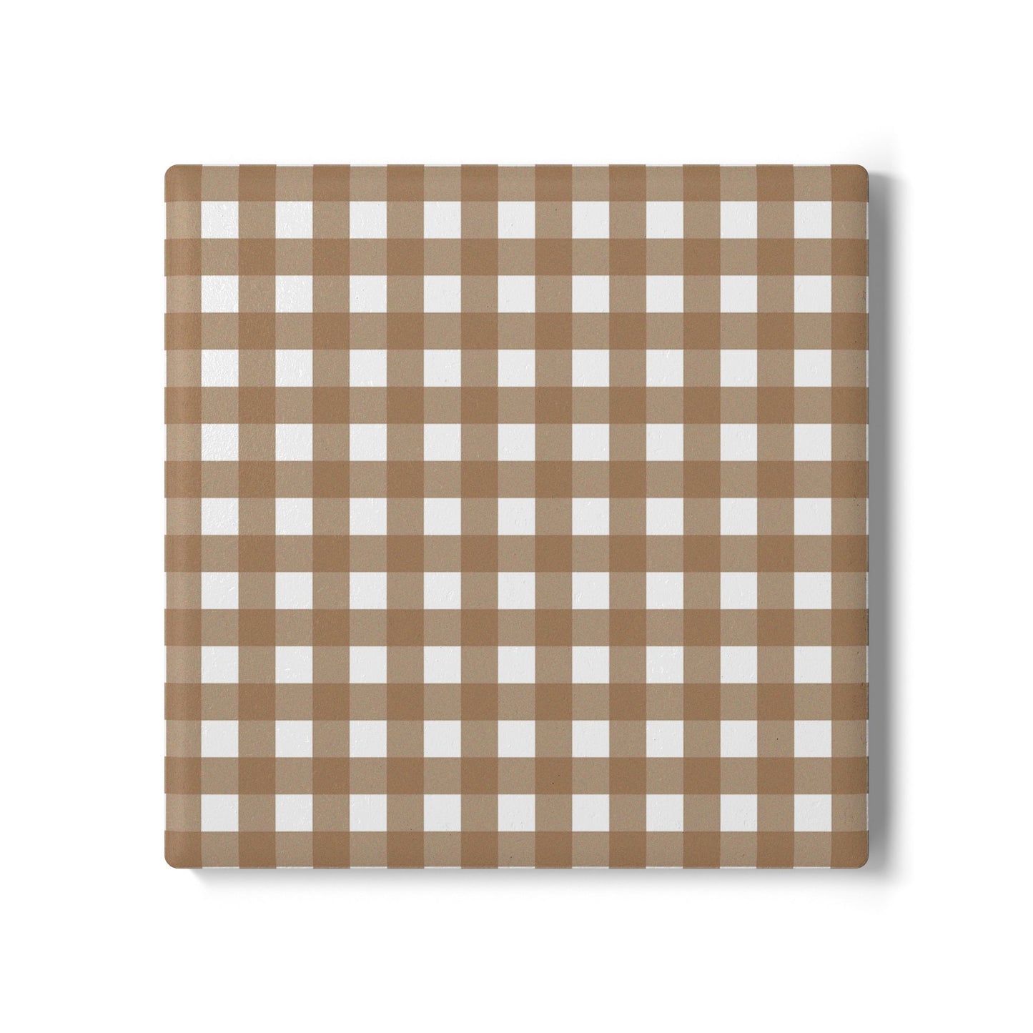 Brown gingham checkered ceramic tile coaster on a white background