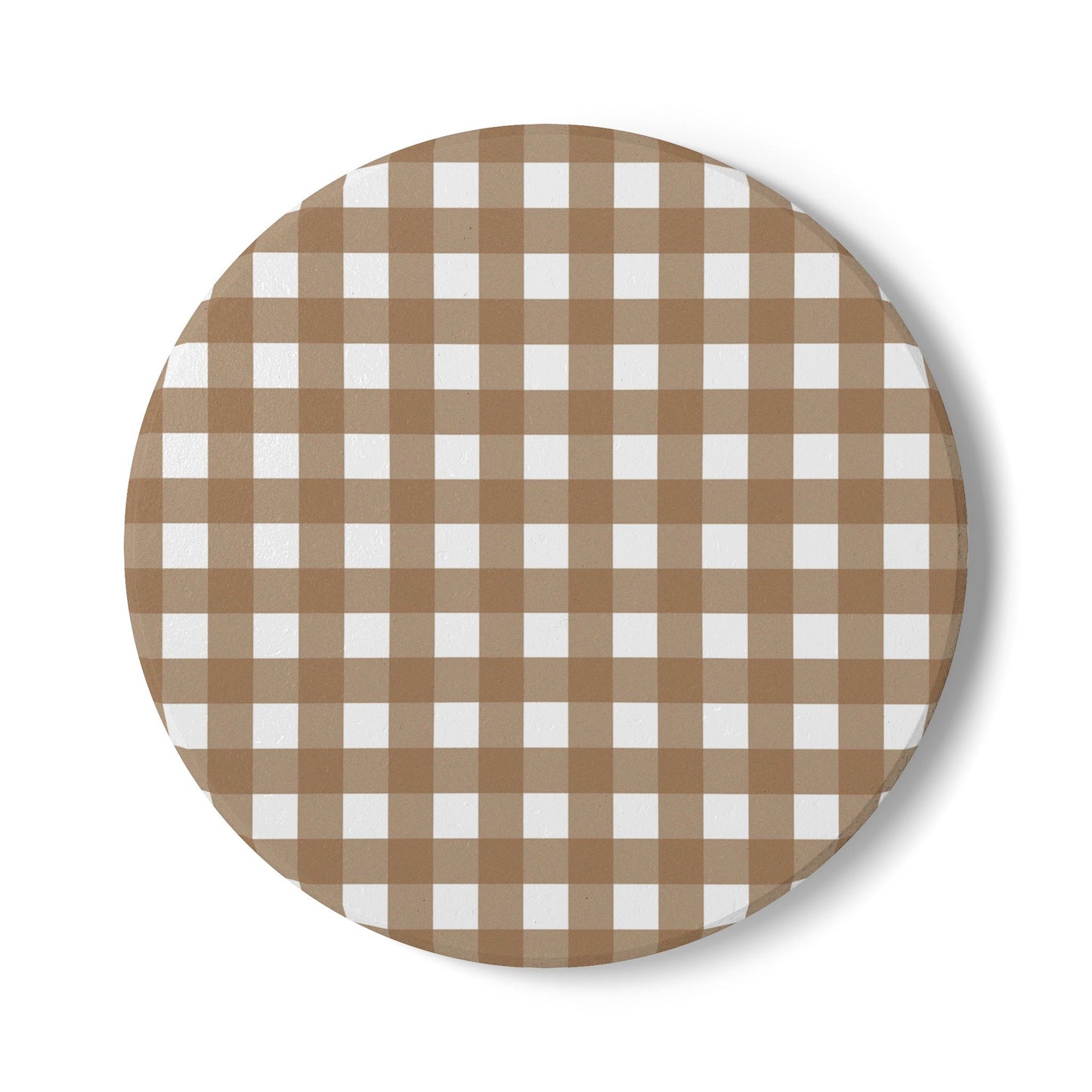 Round ceramic tile coaster with brown and white gingham checkered pattern on a white background