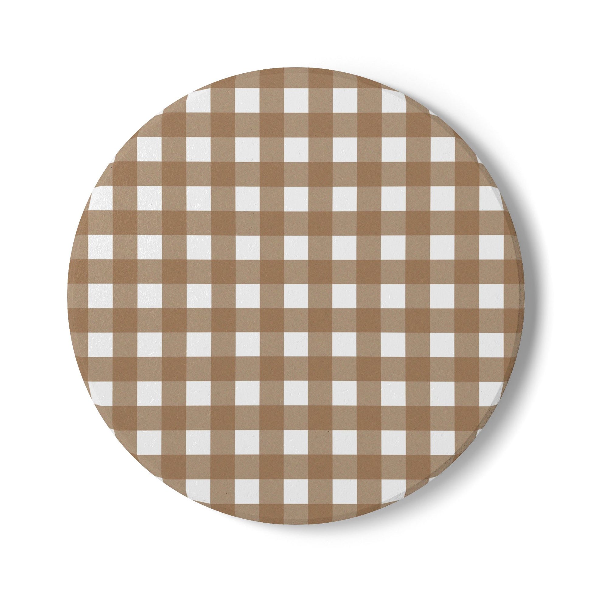 Round ceramic tile coaster with brown and white gingham checkered pattern on a white background