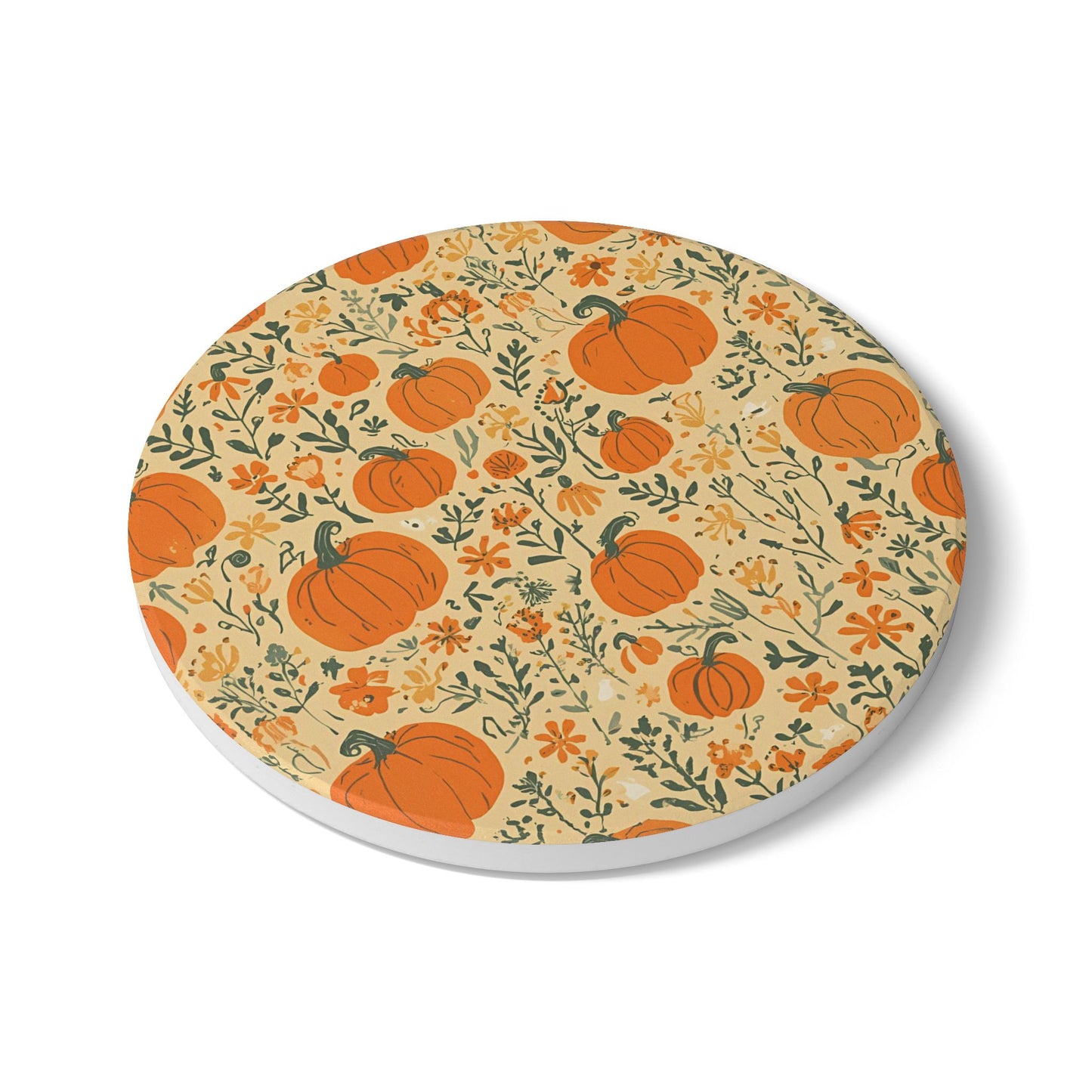Round ceramic tile coaster with pumpkin and floral pattern on a beige background