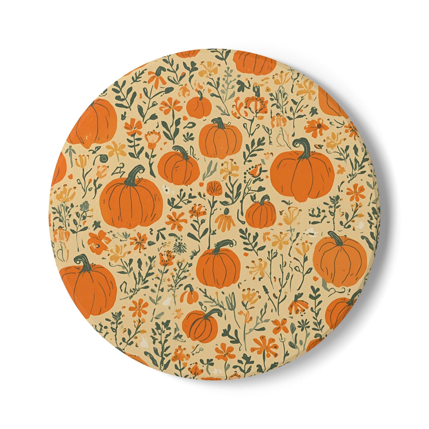 Round ceramic tile coaster with pumpkins and flowers with a beige background on a white background
