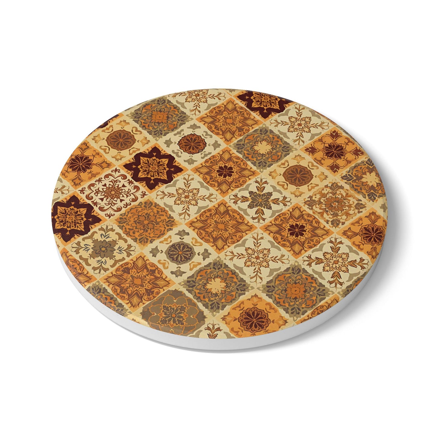 Round ceramic tile coaster with with a pattern of brown, orange, gold, green geometric floral shapes on a white background