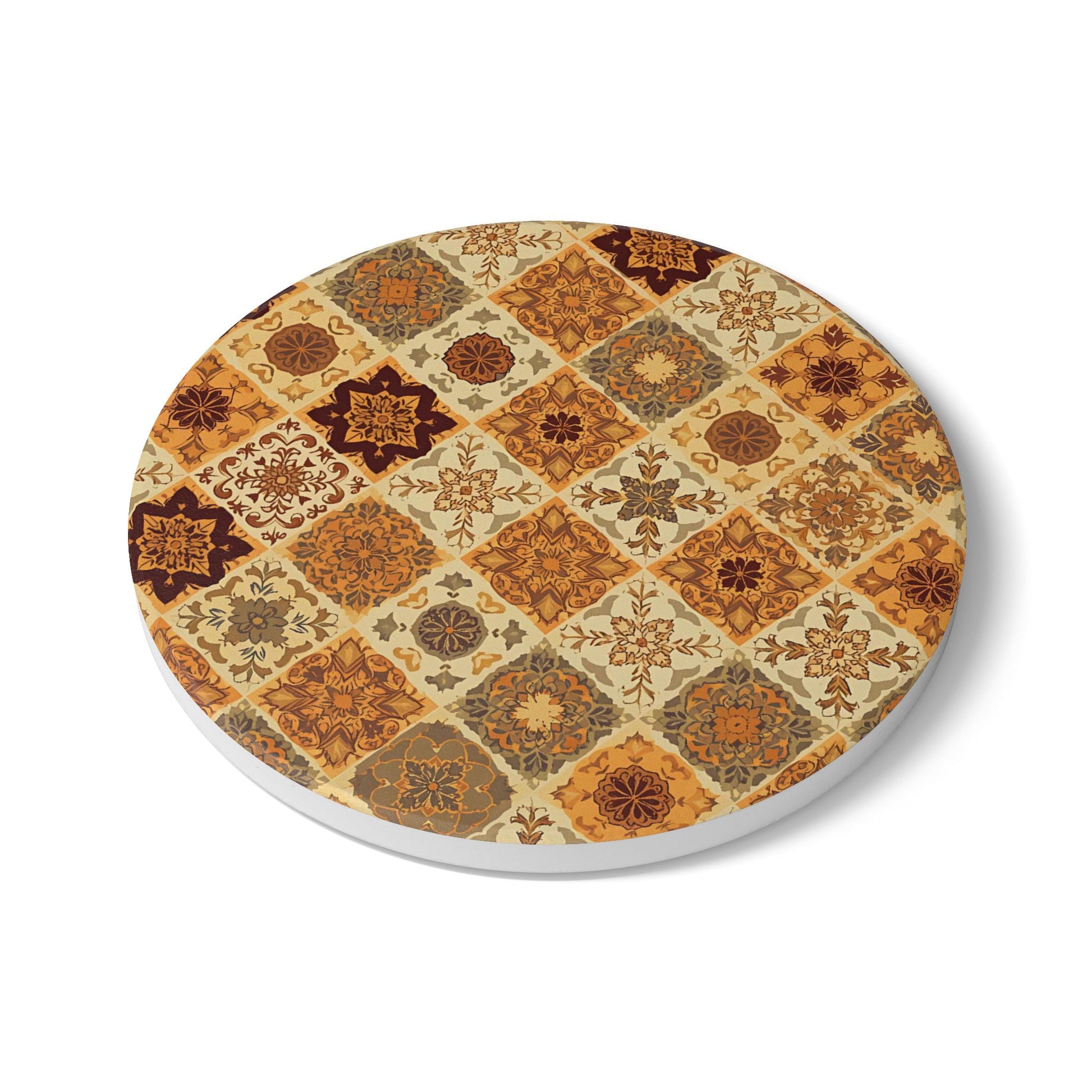 Round ceramic tile coaster with with a pattern of brown, orange, gold, green geometric floral shapes on a white background