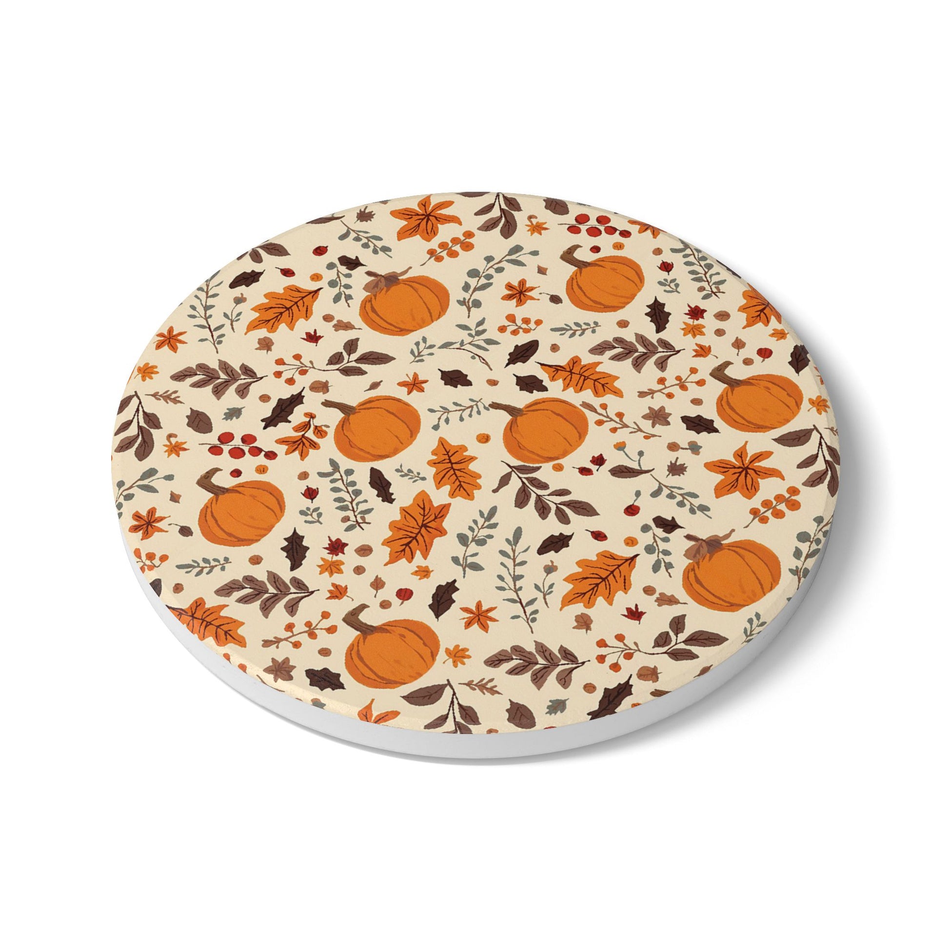Round ceramic tile coaster with autumn-themed design featuring pumpkins and leaves on a beige background