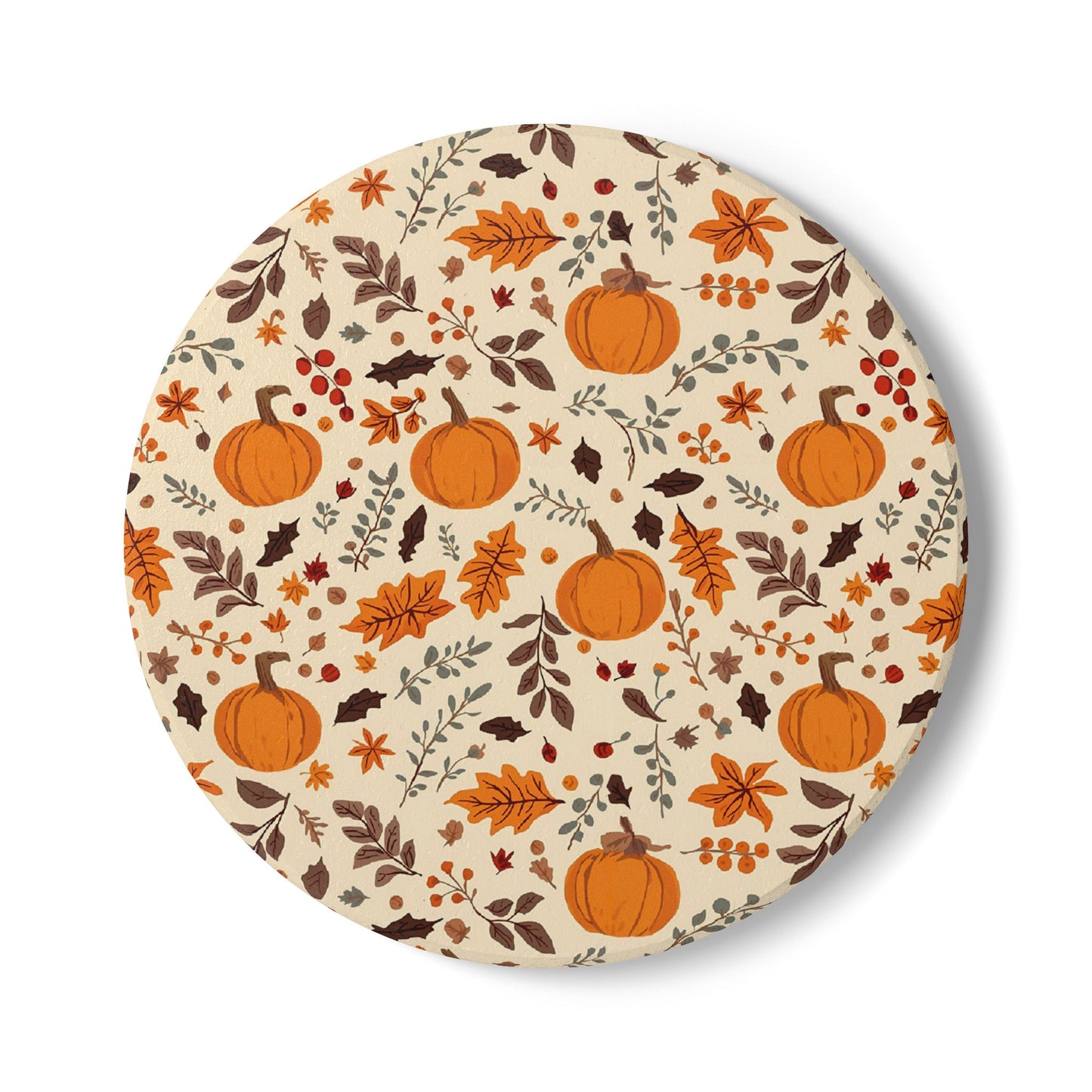 Round ceramic tile coaster with autumn-themed design featuring pumpkins and leaves on a beige background