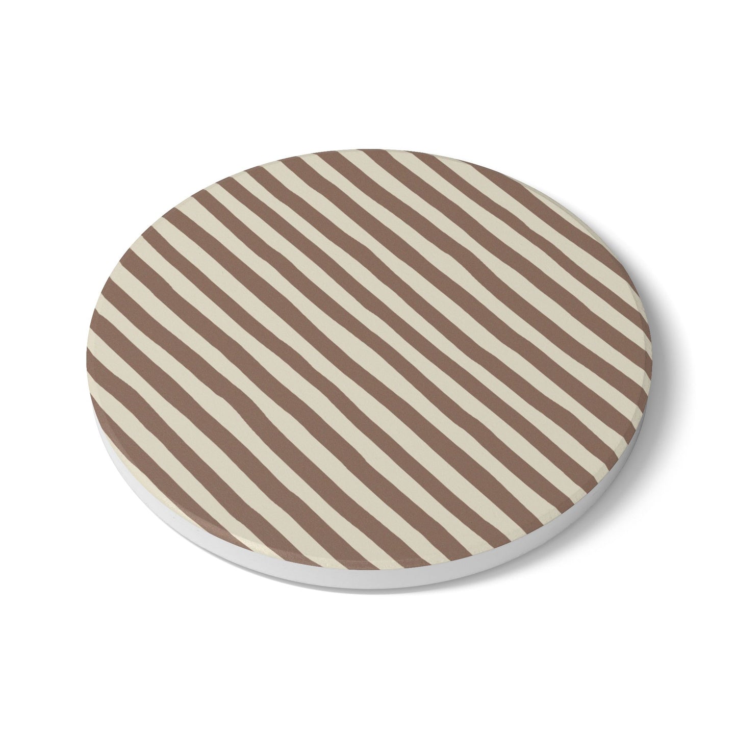 Round tile coaster with brown and beige striped pattern on a white background