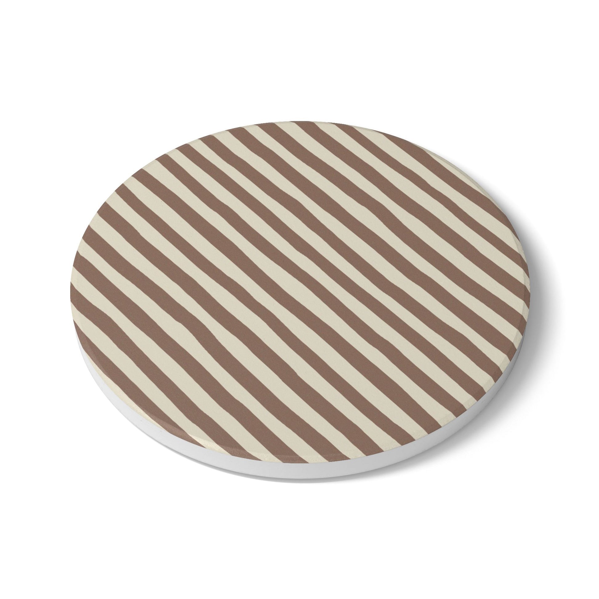 Round tile coaster with brown and beige striped pattern on a white background