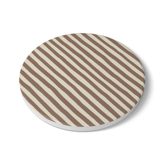 Round tile coaster with brown and beige striped pattern on a white background