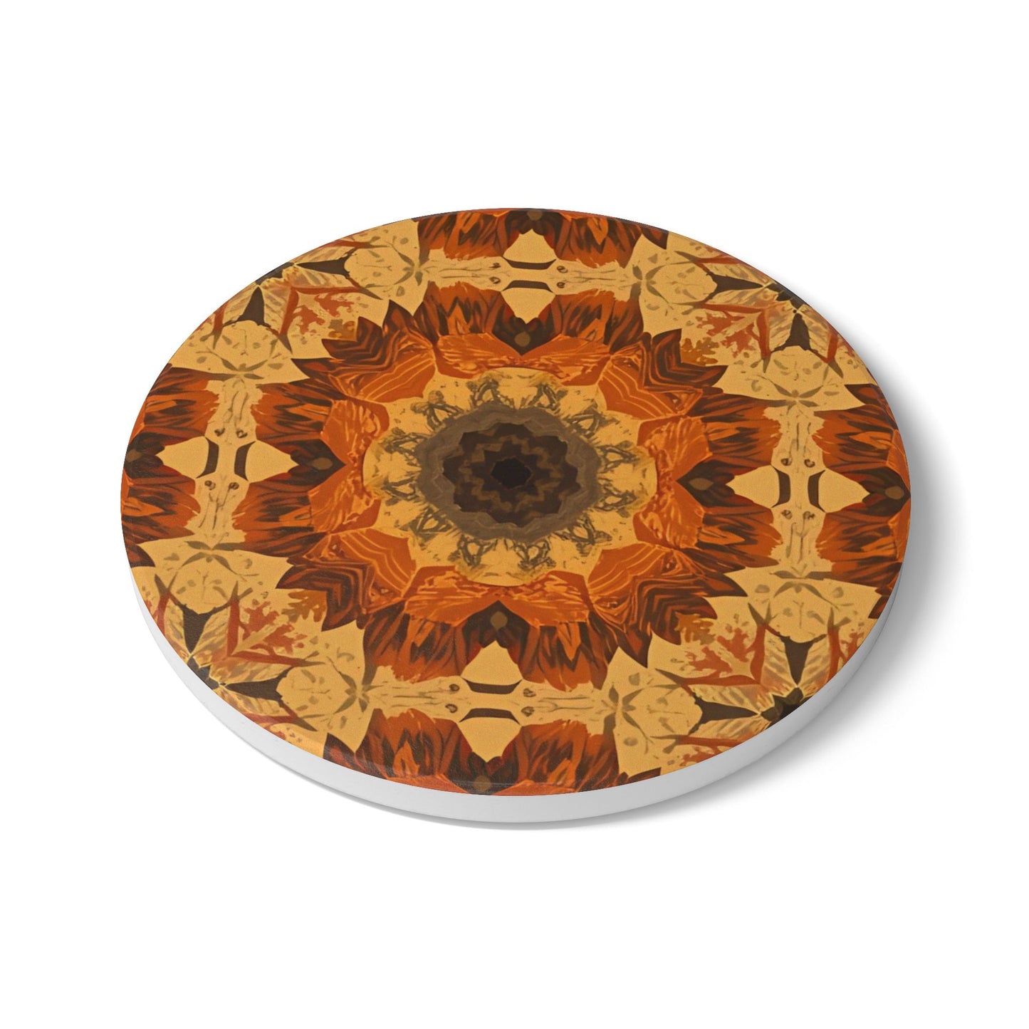 Round ceramic tile coaster with an orange, gray and yellow mandala design on a white background