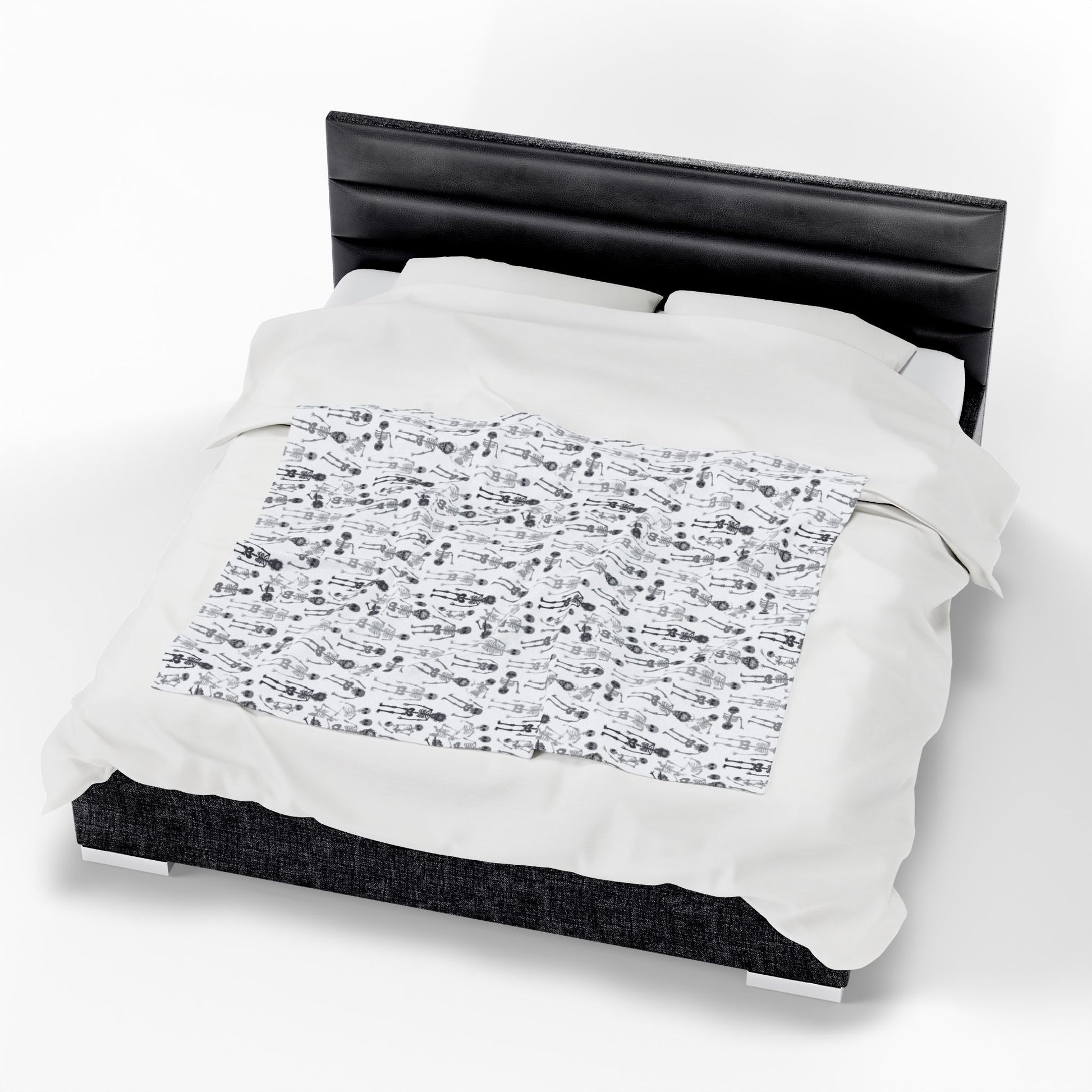 Halloween-themed Skeletons patterned blanket with black and white skeletons on a white background on front of blanket, on a white background