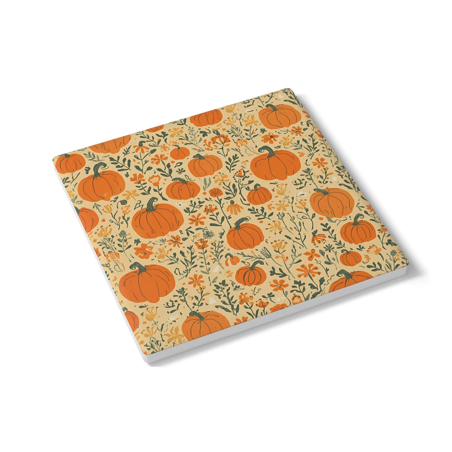 Square ceramic tile coaster with pumpkin and flowers pattern on a white background