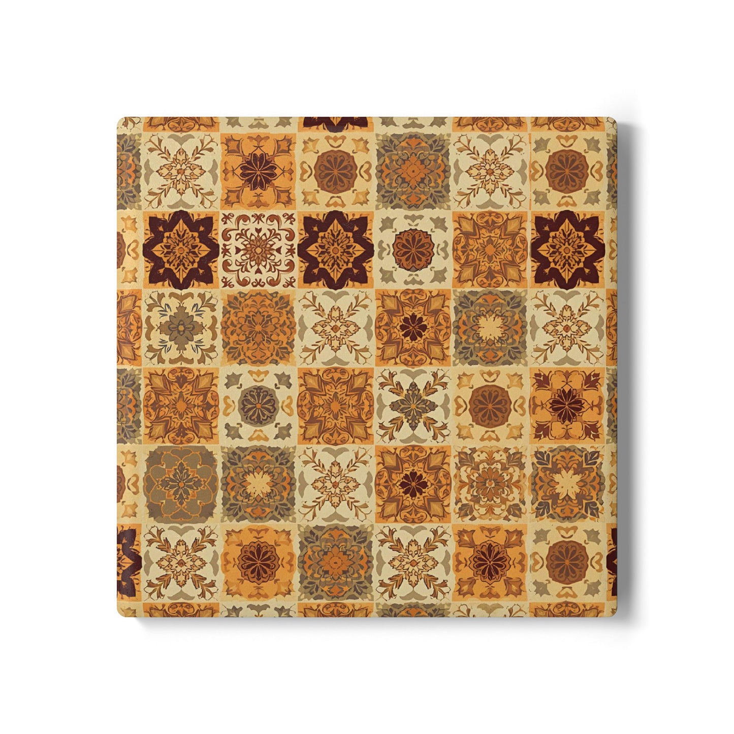 Square ceramic tile coaster with a pattern of square brown, orange, gold and green floral tiles in earthy tones on a white background
