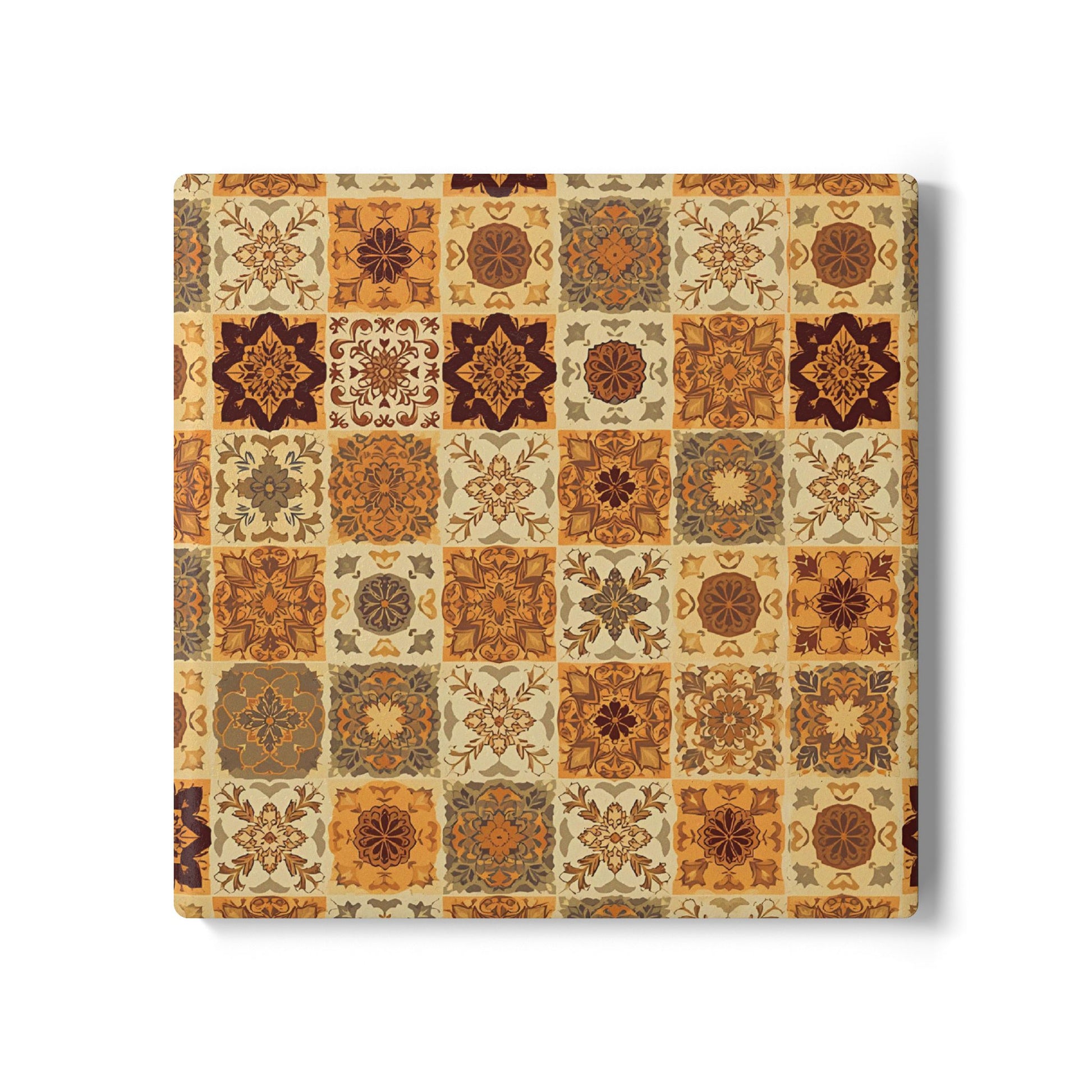Square ceramic tile coaster with a pattern of square brown, orange, gold and green floral tiles in earthy tones on a white background