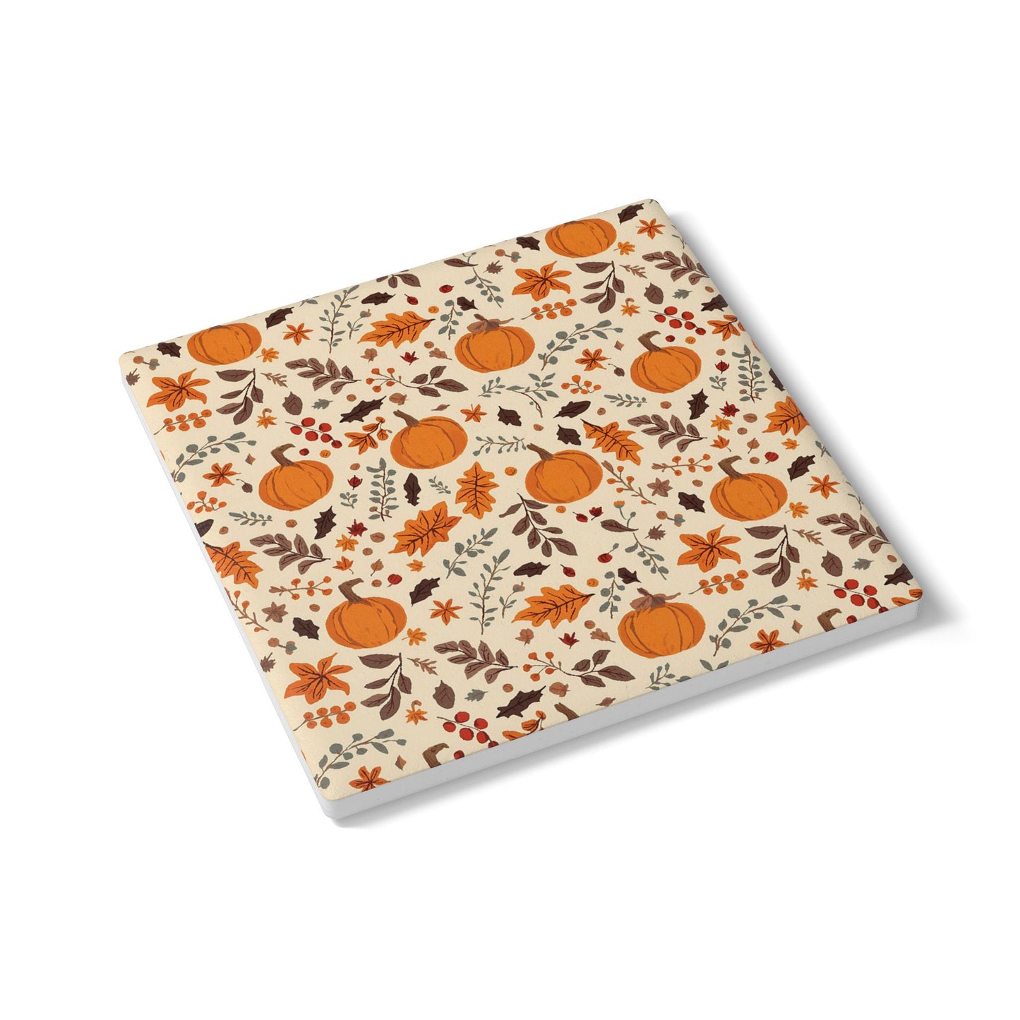 Square ceramic tile coaster with autumn-themed design featuring pumpkins and leaves on a beige background