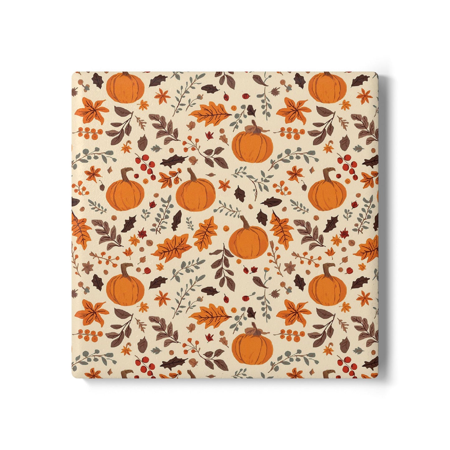 Square ceramic tile coaster with  autumnal design featuring pumpkins and leaves on a beige background