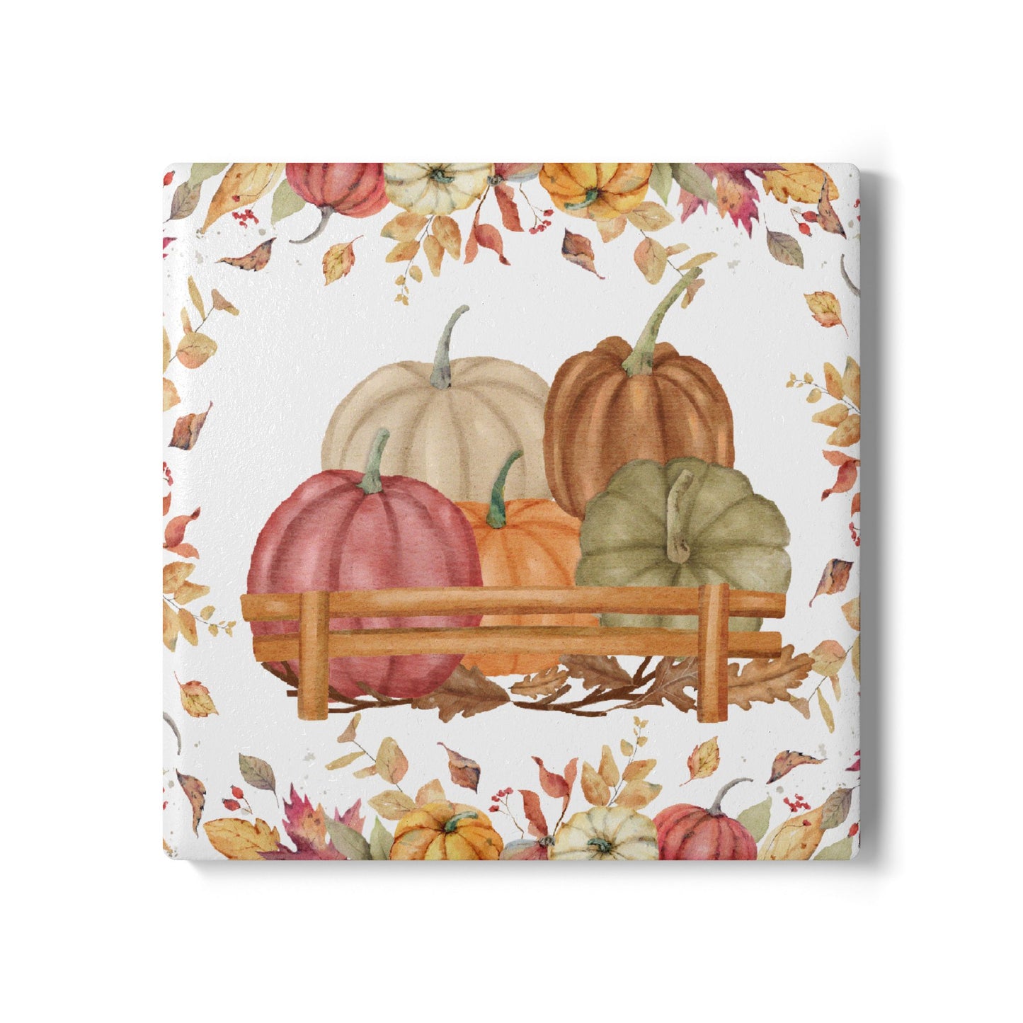 Square ceramic tile coaster with pumpkins and autumn leaves on a white background