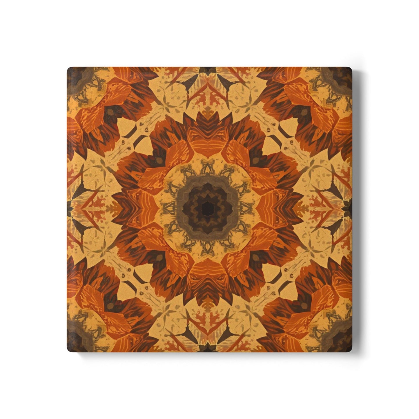 Square tile coaster with orange, gray and yellow mandala pattern with warm colors on a white background