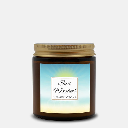 Sun Washed candle in a 4 oz.  jar labeled 'Sun Washed' with sun graphic by Home & Wicks on a white background