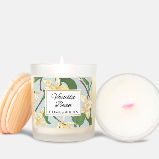 Vanilla Bean candle with pink wood wick and vanilla bean floral label and wooden coaster on a white background