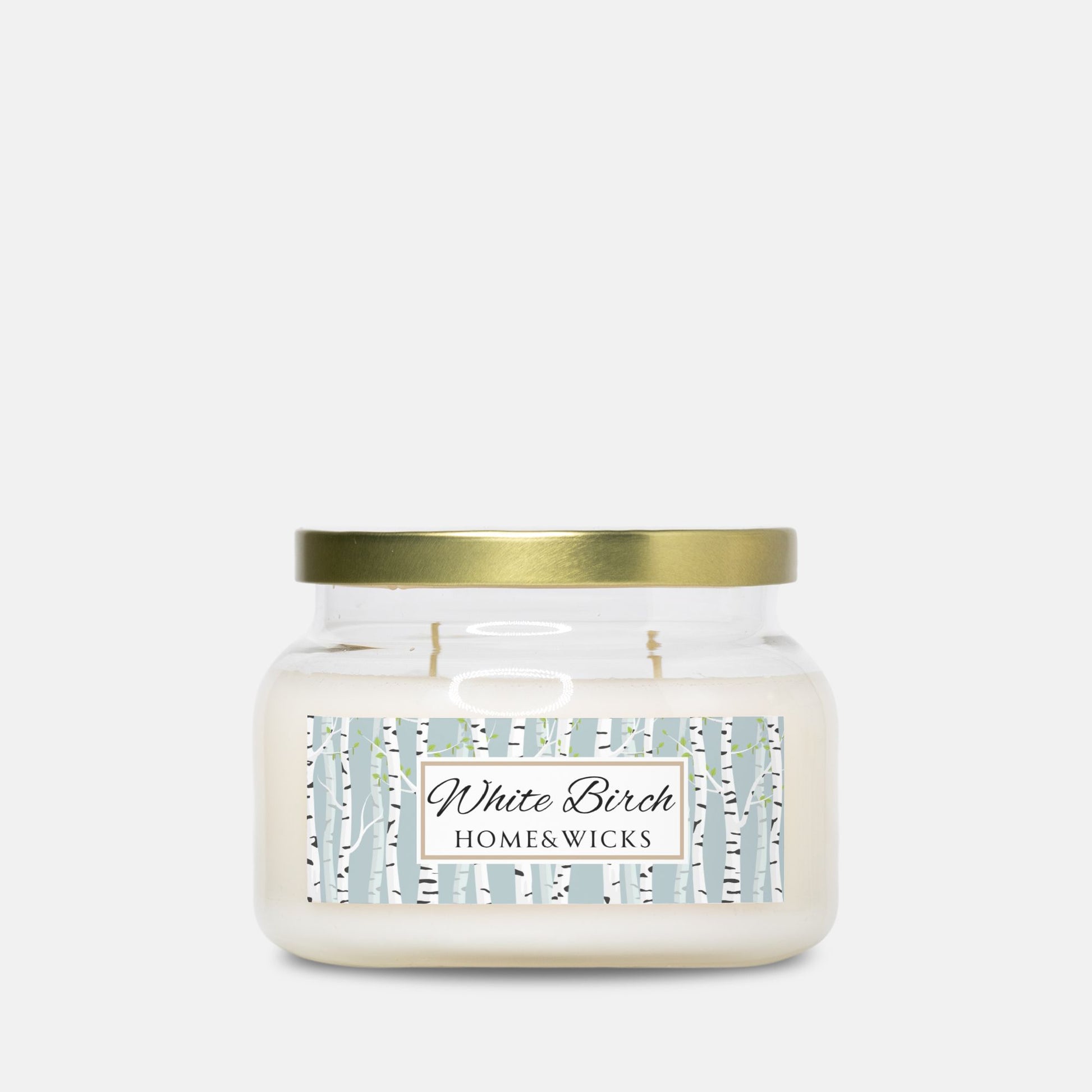 Apothecary candle jar with gold lid and 'White Birch Home & Wicks' label on a white background