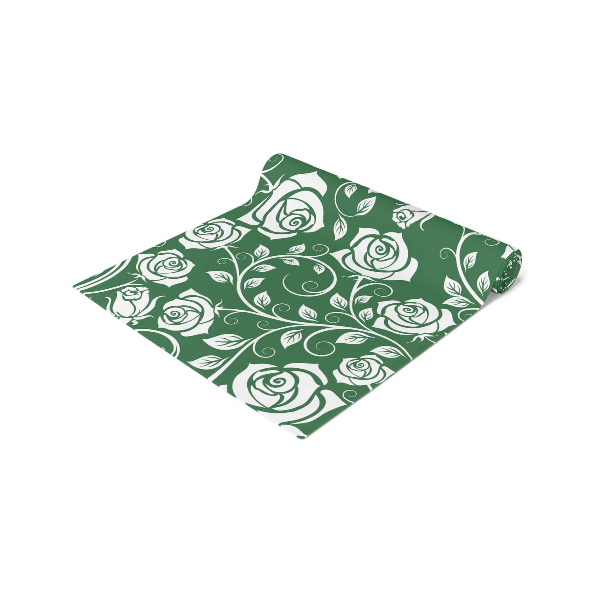 Green table runner with white rose pattern rolled up on a white background