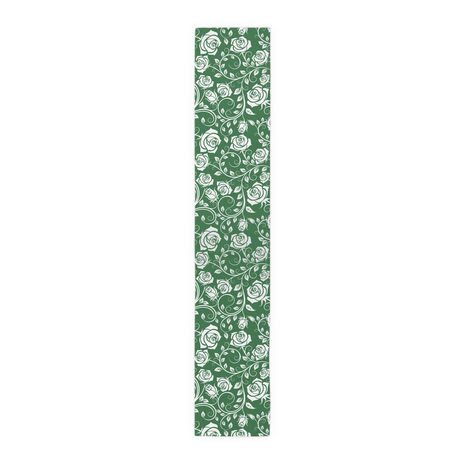 Green table runner with white floral pattern on a white background