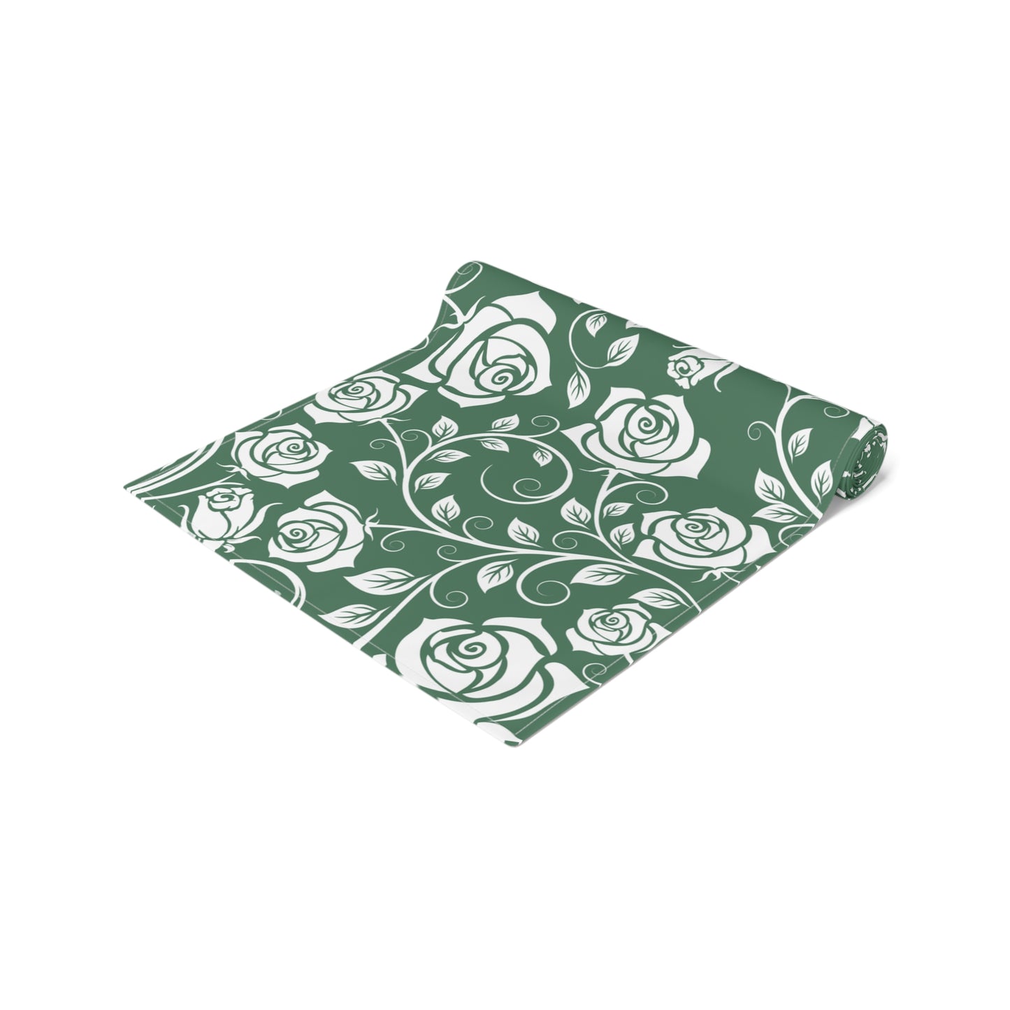 Green table runner with white rose pattern rolled up on a white background