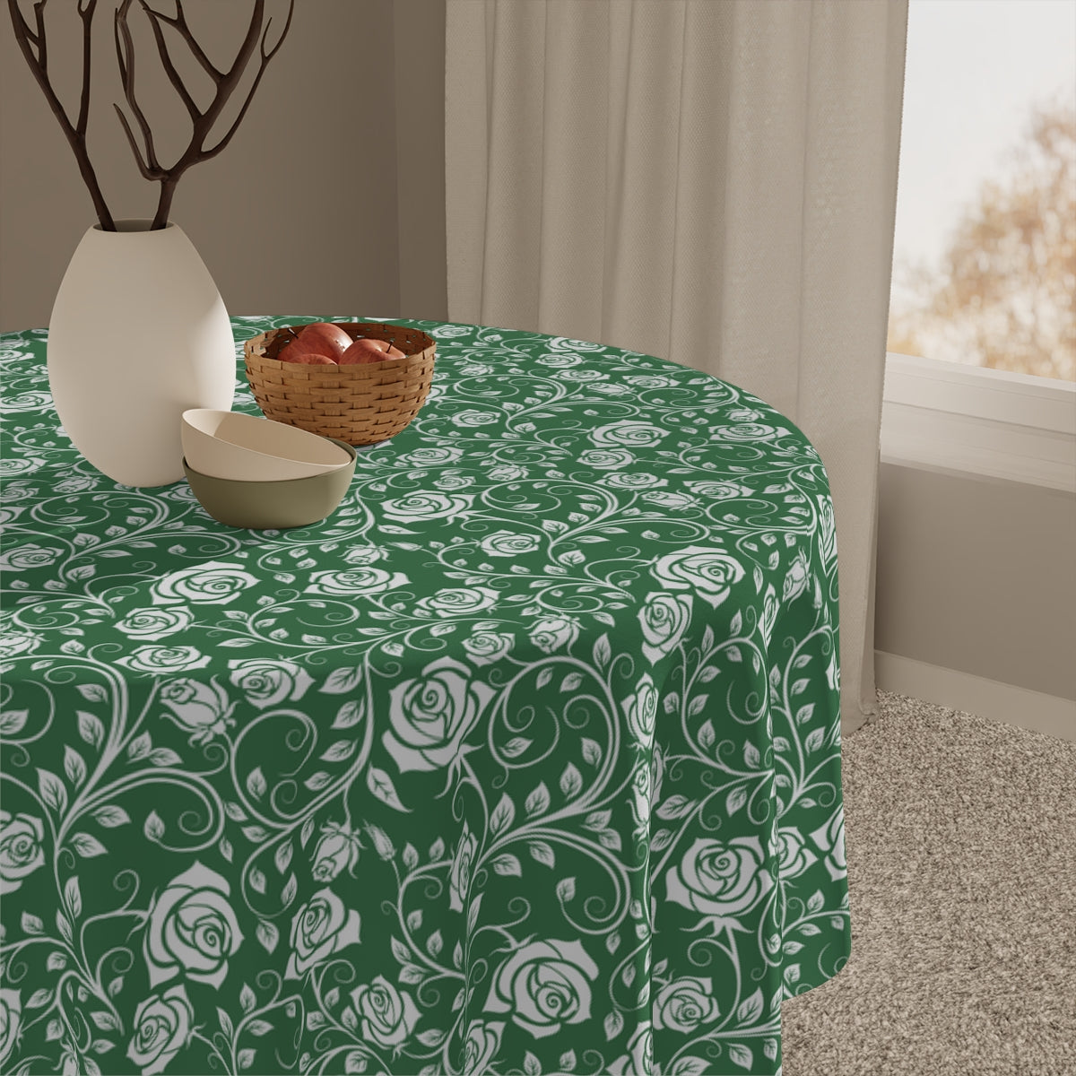 Green and white floral-patterned tablecloth on a table with decorative items.