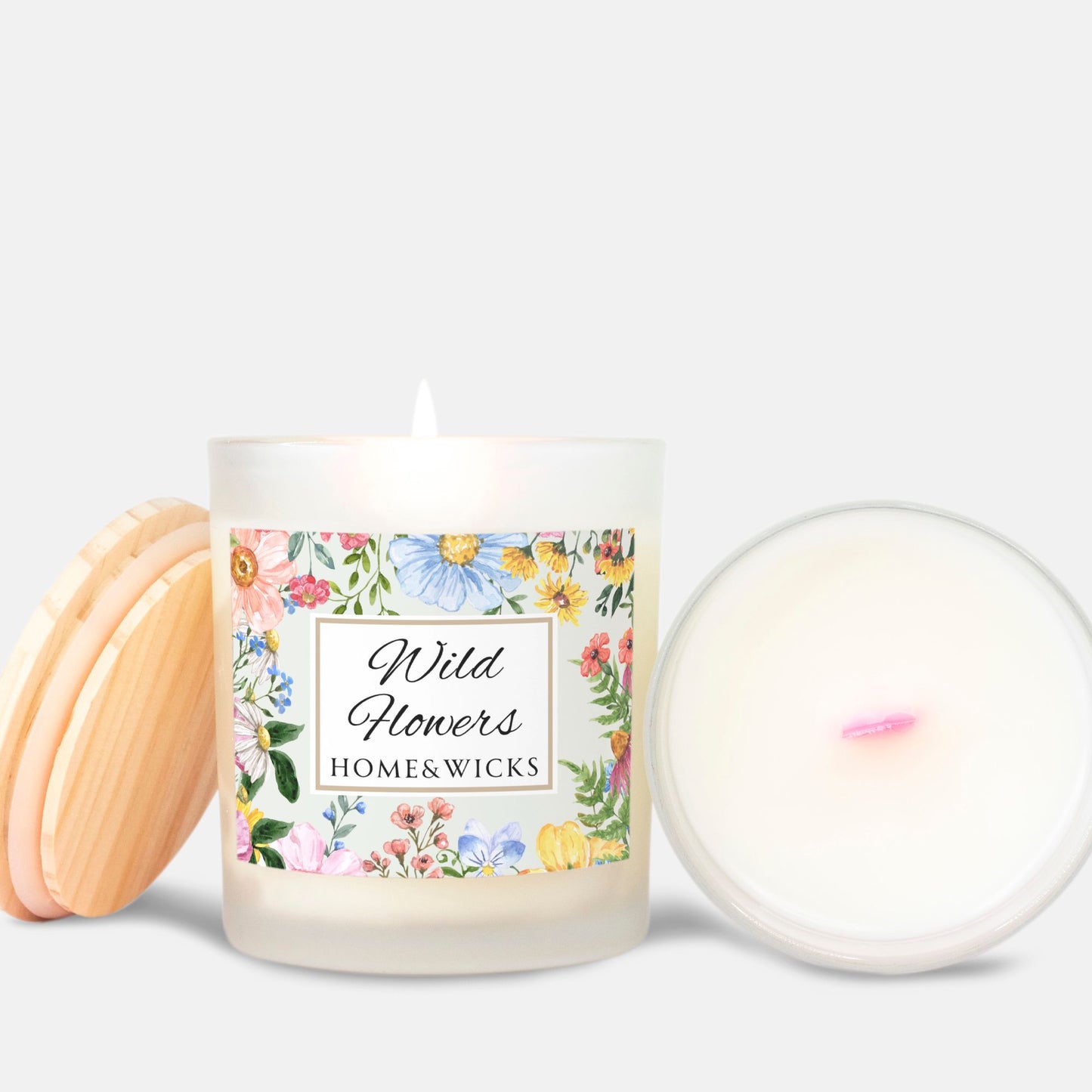 Candle with pink wood wick and a floral label on a white background