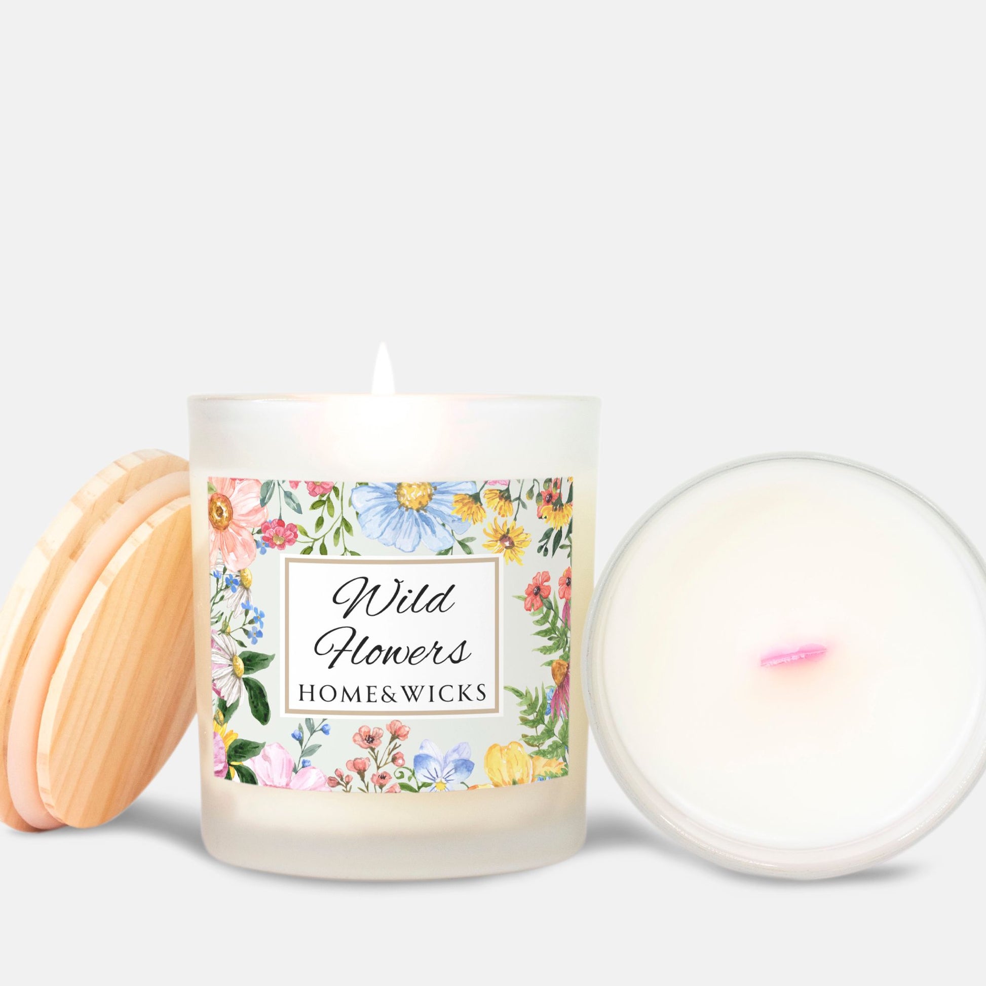 Candle with pink wood wick and a floral label on a white background