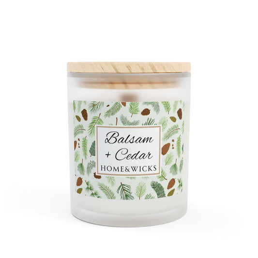 Wood wick candle with 'Balsam + Cedar' label with cones and cedar leaves on a white background by Home & Wicks
