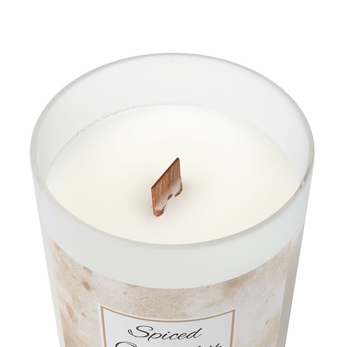 Wood wick white frosted spiced oat milk candle with  a white background