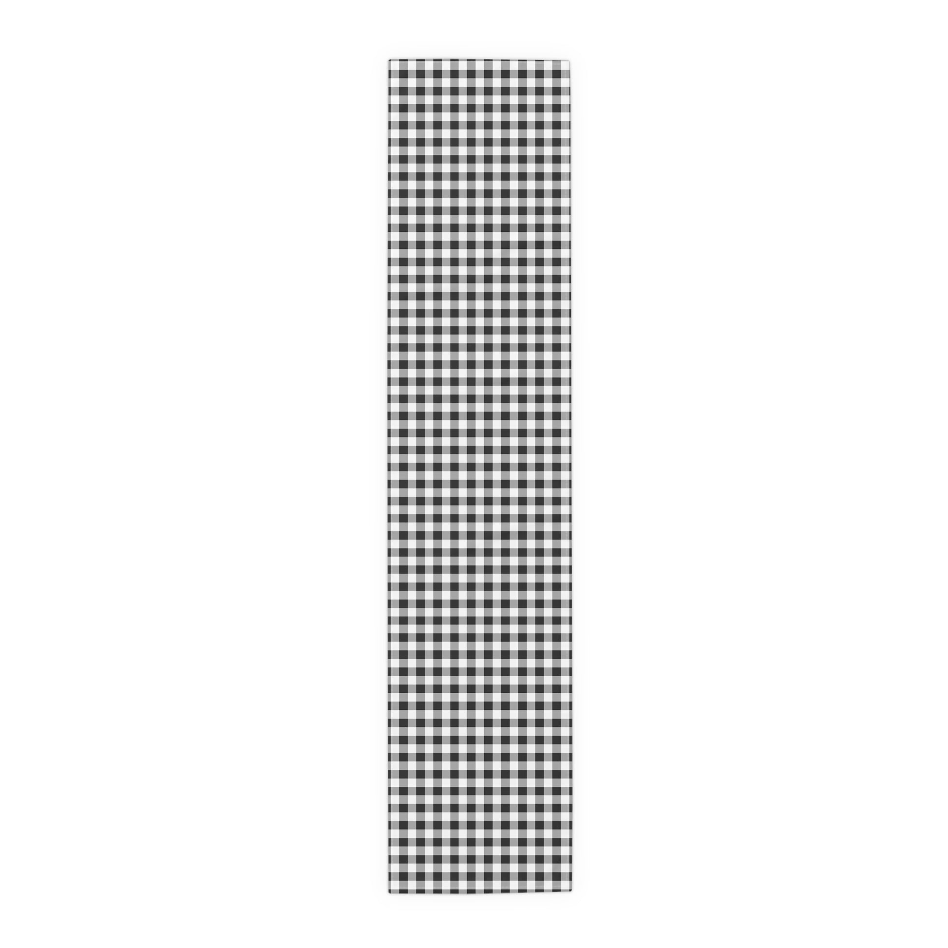 Black and white checkered gingham table runner on a white background