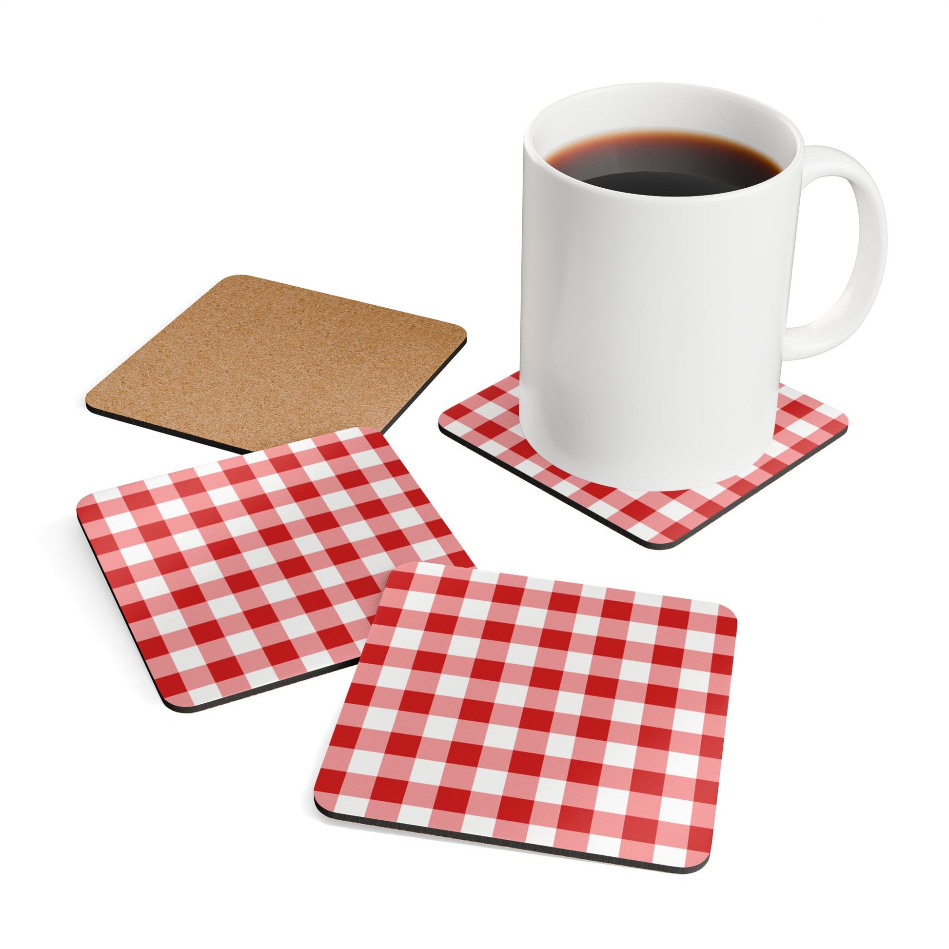 Set of red and white gingham checkered coasters with a mug of coffee on a white background